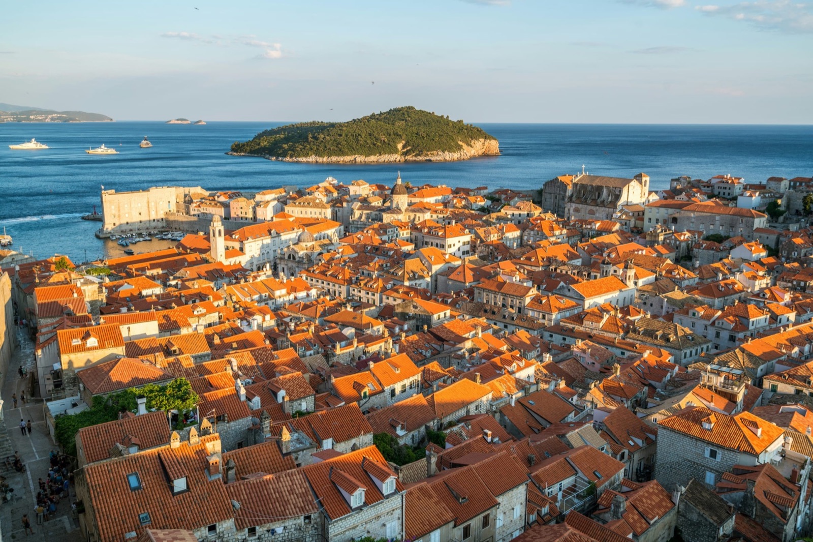 Aerial view of a Dalmatian coastal port with red rooftops surrounded by the Adriatic Sea, Croatia